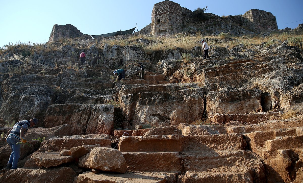 One of the rare theaters carved into a rock is being unearthed in Fethiye Castle